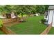 Large backyard with a new fence and mature trees providing privacy, along with an outbuilding at 4605 Tims Pl, Snellville, GA 30039