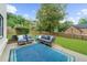 Outdoor patio features stylish seating on a well-manicured lawn with lush greenery at 4605 Tims Pl, Snellville, GA 30039