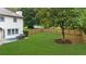 Expansive backyard with a well-maintained lawn, wooden fence, and mature trees offering ample space at 4605 Tims Pl, Snellville, GA 30039