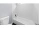 Bathroom with a white bathtub and tiled wall at 4605 Tims Pl, Snellville, GA 30039