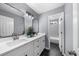 Modern bathroom with double vanity, marble countertop, black hexagon floor tiles and shower-tub combination at 4605 Tims Pl, Snellville, GA 30039