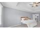 A bedroom with a tray ceiling, a ceiling fan, and neutral decor with a walk-in closet at 4605 Tims Pl, Snellville, GA 30039