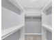 An empty walk-in closet with white shelving and neutral carpeting at 4605 Tims Pl, Snellville, GA 30039