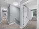 Hallway featuring neutral carpet, light gray walls, and access to multiple rooms at 4605 Tims Pl, Snellville, GA 30039