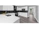 Bright kitchen with black backsplash, white cabinets, and stainless steel appliances at 4605 Tims Pl, Snellville, GA 30039