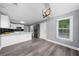 Open kitchen with white countertops, modern lighting, and stainless steel appliances at 4605 Tims Pl, Snellville, GA 30039