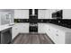 Beautiful kitchen features white cabinets, stainless steel appliances, and modern backsplash at 4605 Tims Pl, Snellville, GA 30039