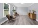 The living area has a neutral paint palette, plenty of natural light, and wood grain floors at 4605 Tims Pl, Snellville, GA 30039