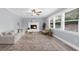 Bright living room features a fireplace, neutral color palette, a ceiling fan, and large windows at 4605 Tims Pl, Snellville, GA 30039