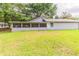 A side backyard view of a screened-in porch with a large grassy area at 6715 Kimberly Mill Rd, Atlanta, GA 30349