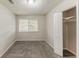 Bedroom featuring a window, carpet flooring, a closet, and neutral walls at 6715 Kimberly Mill Rd, Atlanta, GA 30349