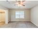 Bedroom featuring a ceiling fan, window, carpet flooring, a closet, and neutral walls at 6715 Kimberly Mill Rd, Atlanta, GA 30349