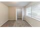 Bedroom features a window, carpet flooring, a closet, and neutral walls at 6715 Kimberly Mill Rd, Atlanta, GA 30349