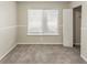 Bedroom featuring a window, carpet flooring, a closet, and neutral walls at 6715 Kimberly Mill Rd, Atlanta, GA 30349