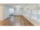 Bright living room with a ceiling fan, hardwood floors, and natural light at 6715 Kimberly Mill Rd, Atlanta, GA 30349