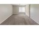 Carpeted living room with a window and a sliding door at 6715 Kimberly Mill Rd, Atlanta, GA 30349