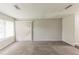 This living room is unfurnished and has carpeted floors with vertical blinds at 6715 Kimberly Mill Rd, Atlanta, GA 30349