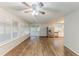 Bright living room with a ceiling fan, hardwood floors, and natural light at 6715 Kimberly Mill Rd, Atlanta, GA 30349