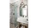 Modern marble bathroom with glass-enclosed shower, floating vanity, and brushed nickel fixtures at 135 Mado Ln, Chattahoochee Hills, GA 30268