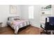 Cozy bedroom with hardwood floors, large window and desk with chair, perfect for a home office at 135 Mado Ln, Chattahoochee Hills, GA 30268