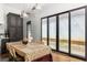 Bright dining room with hardwood floors, modern lighting, and sliding glass doors to a courtyard at 135 Mado Ln, Chattahoochee Hills, GA 30268