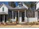 Charming gray cottage style home with inviting front porch and manicured landscaping at 135 Mado Ln, Chattahoochee Hills, GA 30268