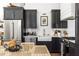 Modern kitchen featuring stainless steel appliances, dark cabinets, and white subway tile backsplash at 135 Mado Ln, Chattahoochee Hills, GA 30268