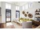 Bright living room featuring high ceilings, wood floors, stylish decor, and large windows at 135 Mado Ln, Chattahoochee Hills, GA 30268