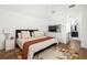 Spacious bedroom with a soft rug, TV, hardwood floors, and a Primary bathroom, full of natural light at 135 Mado Ln, Chattahoochee Hills, GA 30268