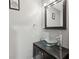 Stylish powder room featuring modern vanity with a glass vessel sink and sleek faucet at 1719 Woodcliff Ne Ct, Atlanta, GA 30329