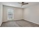Neutral bedroom featuring carpet floors, ceiling fan, and a window for natural light at 1719 Woodcliff Ne Ct, Atlanta, GA 30329
