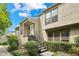 Two-story condo featuring a cozy front porch with stairs leading to the entrance and manicured landscaping at 1719 Woodcliff Ne Ct, Atlanta, GA 30329