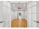 View through french doors into a living space with hardwood floors and a large window at 1719 Woodcliff Ne Ct, Atlanta, GA 30329