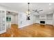Spacious living room featuring hardwood floors, a ceiling fan, fireplace and built-in shelves at 1719 Woodcliff Ne Ct, Atlanta, GA 30329