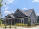 Charming single story home with gray siding, stone accents, well-manicured lawn and inviting curb appeal at 2255 Windsor Bluffs Dr, Cumming, GA 30041