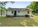 Home exterior with a grassy backyard and mature trees at 354 Henry Aaron Sw Ave, Atlanta, GA 30310