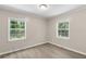 A bedroom featuring two bright windows and light wood-look flooring at 354 Henry Aaron Sw Ave, Atlanta, GA 30310