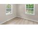 Comfortable bedroom with laminate flooring, and two windows for natural lighting at 354 Henry Aaron Sw Ave, Atlanta, GA 30310