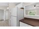 Functional kitchen featuring a refrigerator, laminate flooring, and a view of bedroom at 354 Henry Aaron Sw Ave, Atlanta, GA 30310