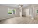 Open living room featuring new flooring, fresh neutral paint, and large windows at 354 Henry Aaron Sw Ave, Atlanta, GA 30310