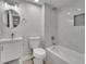 Bathroom with vanity, toilet, mirror and shower-tub combo with marble tile at 5400 Mill Run Dr, Marietta, GA 30068
