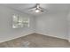 A light-filled bedroom showcases a ceiling fan and a large window with blinds at 5400 Mill Run Dr, Marietta, GA 30068