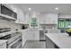Bright kitchen featuring white cabinets, modern appliances, and countertops, ideal for cooking and entertaining at 5400 Mill Run Dr, Marietta, GA 30068