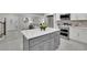 Modern kitchen featuring a gray island with a white countertop and stainless steel appliances at 5400 Mill Run Dr, Marietta, GA 30068
