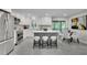 Modern kitchen boasts white cabinets, stainless steel appliances, and an island with bar seating at 5400 Mill Run Dr, Marietta, GA 30068
