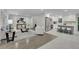 Open concept living space with modern kitchen, stainless appliances, island seating, and stylish furniture at 5400 Mill Run Dr, Marietta, GA 30068