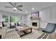 Bright living room with a stone fireplace, modern ceiling fan, and lots of natural light at 5400 Mill Run Dr, Marietta, GA 30068