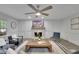 Comfortable living room with a stone fireplace, ceiling fan, and lots of natural light at 5400 Mill Run Dr, Marietta, GA 30068