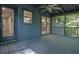 An inviting screened-in back porch featuring a ceiling fan and a view of the surrounding trees at 5400 Mill Run Dr, Marietta, GA 30068