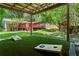 Covered backyard area with a view of the deck, lawn, and a cornhole game at 1734 8Th St, Atlanta, GA 30341